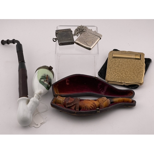 611 - Objects of Vertu: Objects of Vertu: A 19th century cased meerschaum pipe, carved as a pair of linked... 