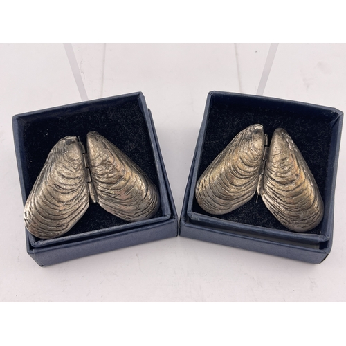 614 - Hallmarked Silver: Hallmarked Silver: Two boxed sterling silver folding mussel shells, a 925 marked ... 