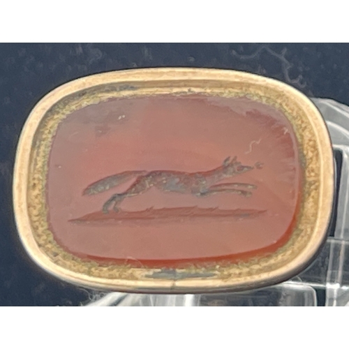 623 - Collectables: Late 19th century gold cased fob seal with a carnelian carved with a running fox. Tota... 