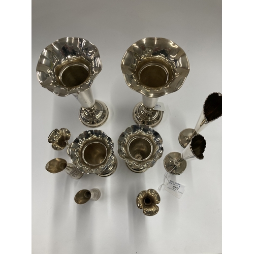 657 - Hallmarked Silver: Hallmarked Silver: A pair of trumpet vases, London 1928, with loaded bases, 22cm;... 