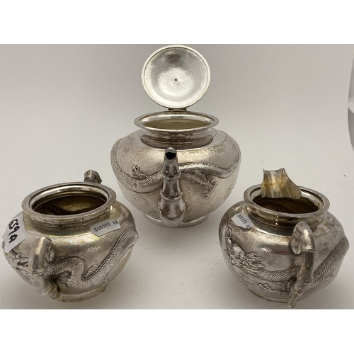 659a - Silver: Silver: A Chinese silver three piece tea set, each with all over planished decoration embell... 