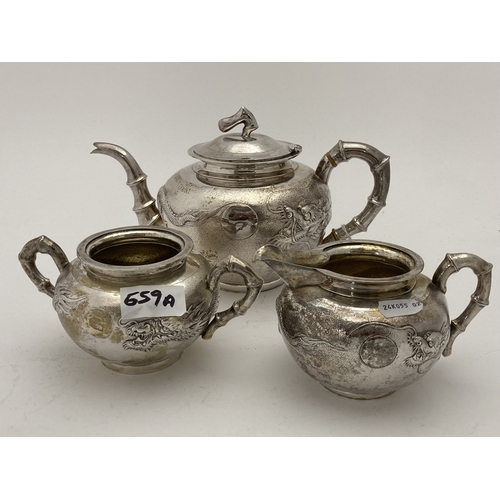 659a - Silver: Silver: A Chinese silver three piece tea set, each with all over planished decoration embell... 