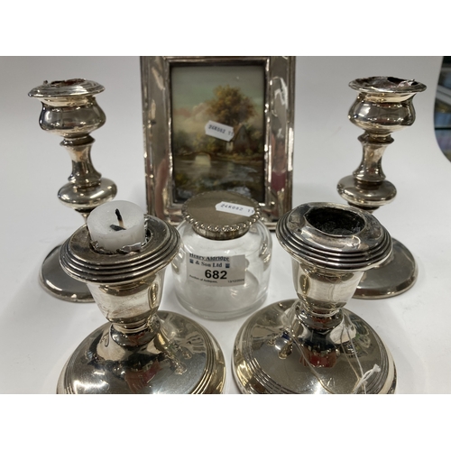 682 - Hallmarked Silver: Hallmarked Silver: Two pairs of silver candlesticks, a picture frame, and a silve... 