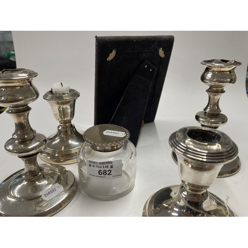 682 - Hallmarked Silver: Hallmarked Silver: Two pairs of silver candlesticks, a picture frame, and a silve... 