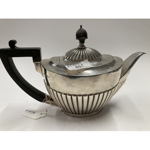 691 - Hallmarked Silver: Hallmarked Silver: A gadrooned silver teapot by Roberts & Belk, Sheffield 191... 