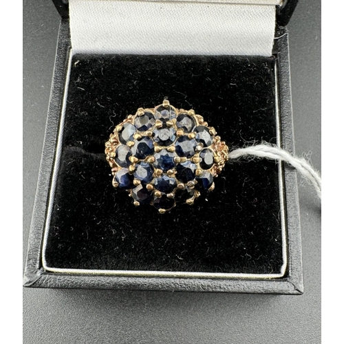 758 - Jewellery: Jewellery: A 9ct gold and sapphire cluster ring with a pierced bark effect mount, UK size... 