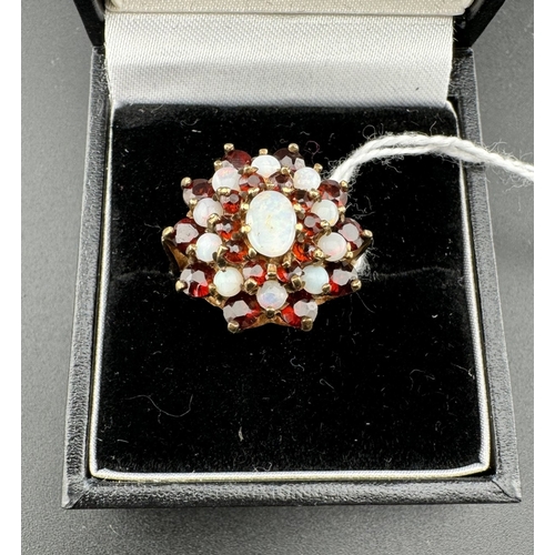 759 - Jewellery: Jewellery: A 9ct gold, opal and garnet cluster ring, the head 1.8cm across. UK size N, 4.... 