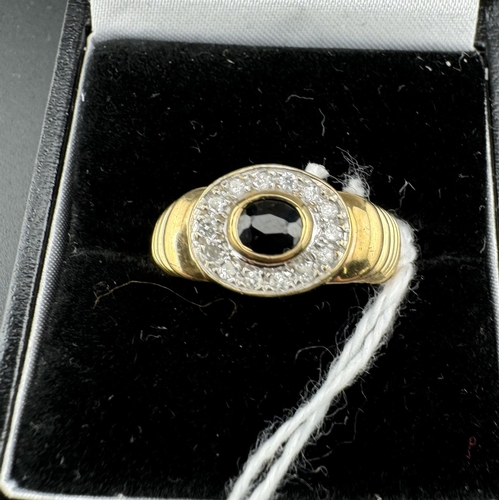 763 - Jewellery: Jewellery: A 9ct gold ring, set a central oval sapphire within a halo of white metal set ... 