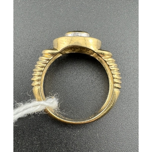 763 - Jewellery: Jewellery: A 9ct gold ring, set a central oval sapphire within a halo of white metal set ... 