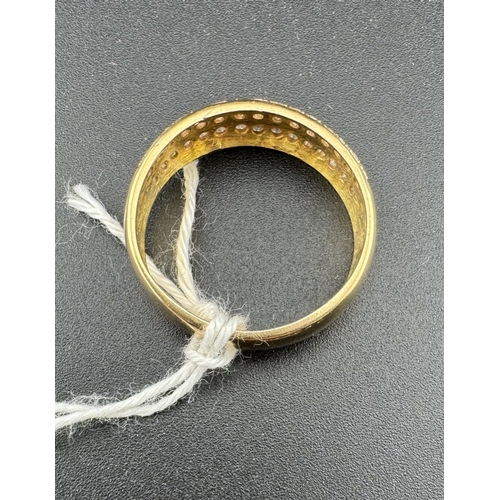 766 - Jewellery: Jewellery: A yellow metal ring, marked '18C' and testing as such, set with three rows of ... 