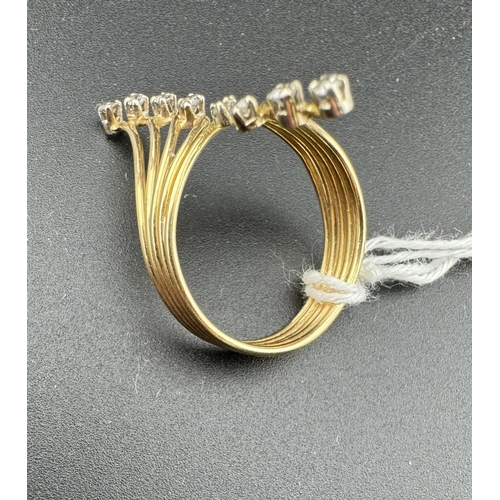 776 - Jewellery: Jewellery: A yellow metal and diamond floral spray ring, the band composed of four wires ... 