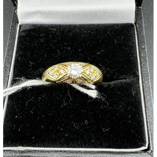 779 - Jewellery: Jewellery: An 18ct yellow gold ring, a central 20 point diamond within a frame of 12 smal... 