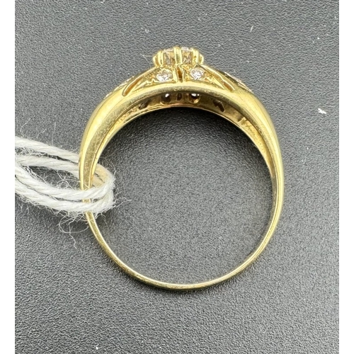 779 - Jewellery: Jewellery: An 18ct yellow gold ring, a central 20 point diamond within a frame of 12 smal... 