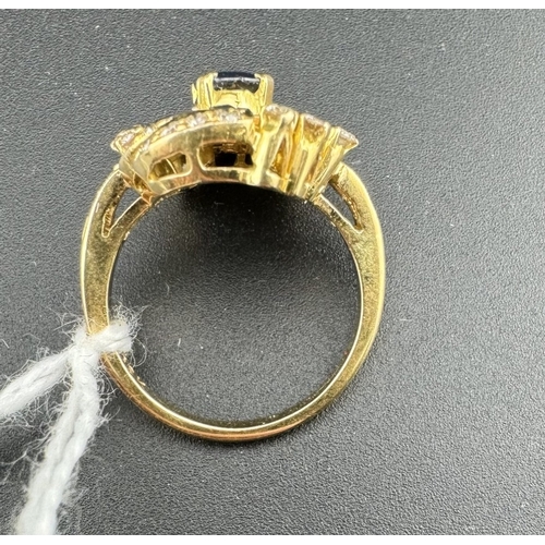 780 - Jewellery: Jewellery: A yellow metal ring, marked 18K and testing as such, with central oval sapphir... 