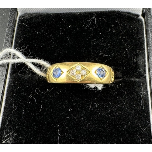 785 - Jewellery: Jewellery: A yellow metal ring, marked 18ct and testing as such, gypsy set with two sapph... 