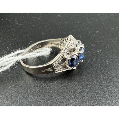 798 - Jewellery: Jewellery: A white metal ring, marked 18k and testing as such, set with four sapphires ea... 