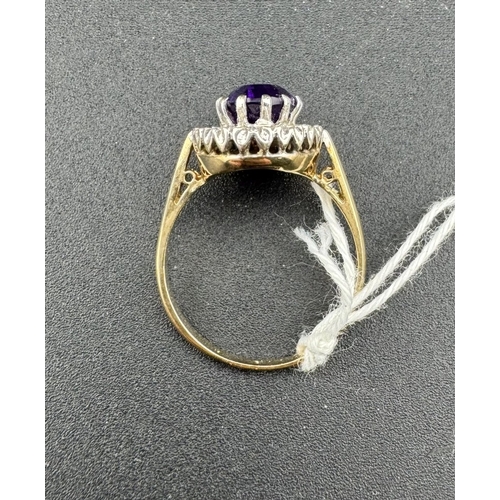 804 - Jewellery: Jewellery: A 9ct gold ring, set a central amethyst in a raised mount above a halo of smal... 