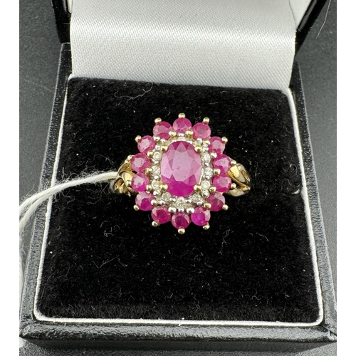 806 - Jewellery: Jewellery: A 9ct gold target style ring set with a central enhanced ruby within a ring of... 