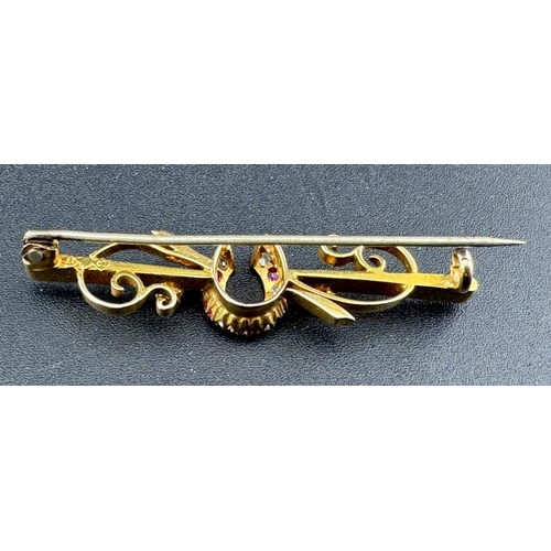 821 - Jewellery: Jewellery: A 15ct gold bar brooch, a central horseshoe set with alternate diamonds and ru... 