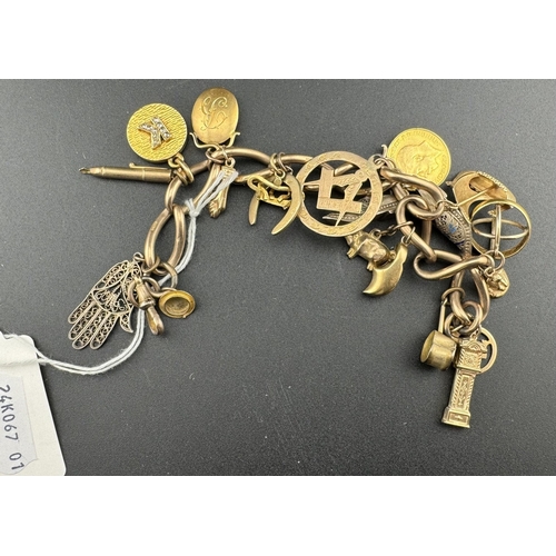 829 - Jewellery: Jewellery: A 9ct gold charm bracelet, suspended with around 20 charms, to include: a 1914... 