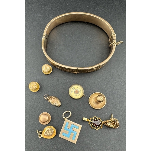 835 - Jewellery: Jewellery: A 9ct gold hinged bangle with safety chain, an enamelled gold Buddhist pendant... 