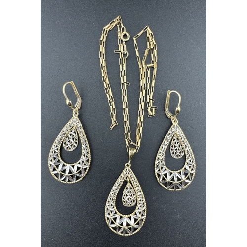 859 - Jewellery: Jewellery: A 14ct yellow and white gold pendant with matching earrings, each pierced with... 