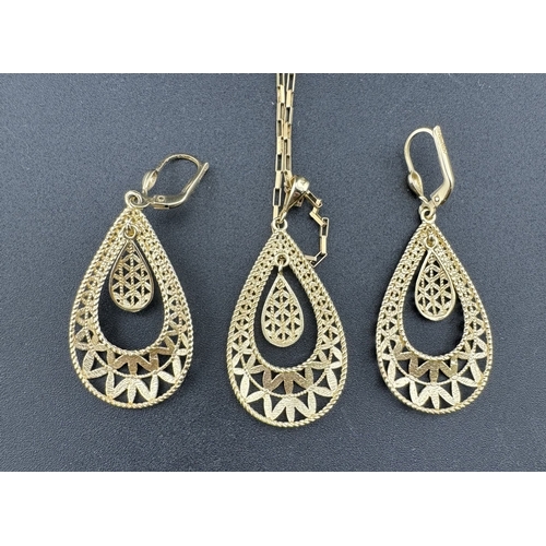 859 - Jewellery: Jewellery: A 14ct yellow and white gold pendant with matching earrings, each pierced with... 