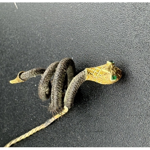 861 - Jewellery: Jewellery: An early 19th century stick pin, the head set with a coiled snake in human hai... 