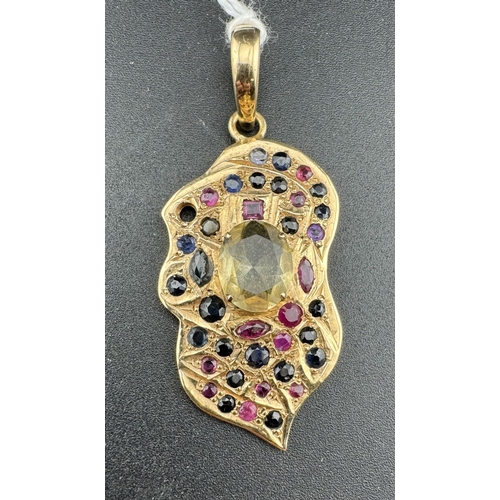 866 - Jewellery: Jewellery: A yellow metal leaf shaped pendant, probably Indian, set with rubies, sapphire... 