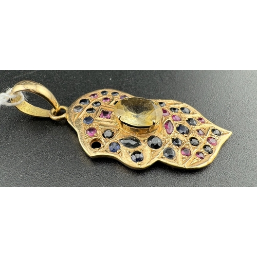 866 - Jewellery: Jewellery: A yellow metal leaf shaped pendant, probably Indian, set with rubies, sapphire... 