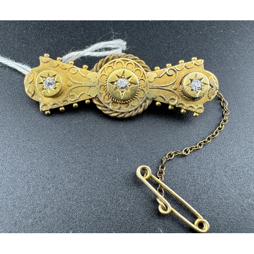 869 - Jewellery: Jewellery: A 15ct gold bar brooch set with three diamonds, the rear a glazed panel holdin... 