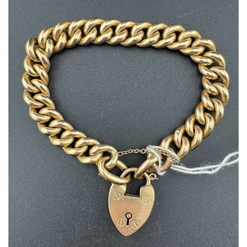 877 - Jewellery: Jewellery: A 15ct yellow gold curb link bracelet, with heart shaped clasp. 19cm, 26.6g.... 