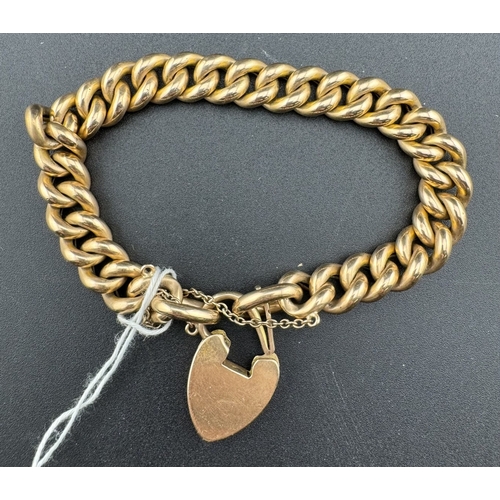 877 - Jewellery: Jewellery: A 15ct yellow gold curb link bracelet, with heart shaped clasp. 19cm, 26.6g.... 