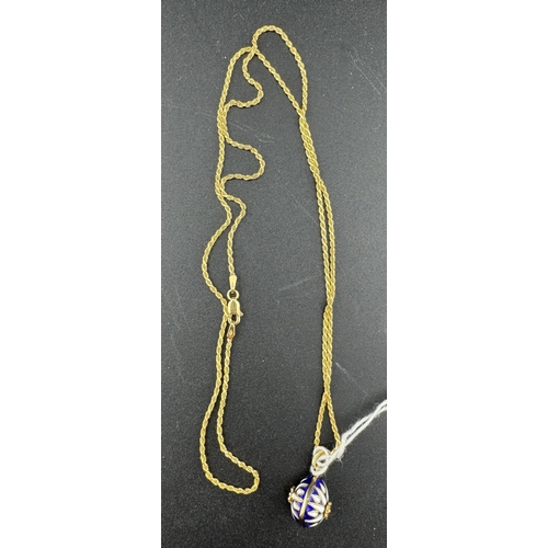 880 - Jewellery: Jewellery: An enamelled gold egg style pendant necklace, the 60cm chain marked 750 and te... 