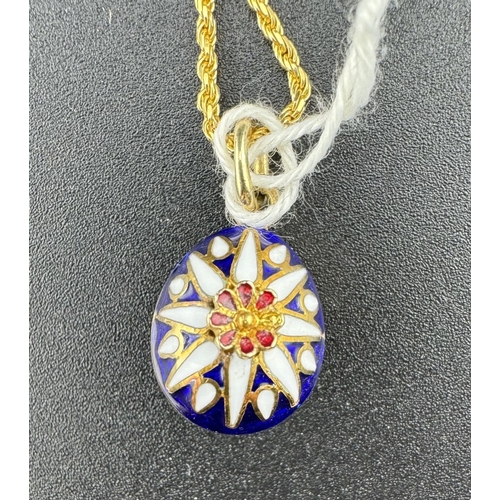 880 - Jewellery: Jewellery: An enamelled gold egg style pendant necklace, the 60cm chain marked 750 and te... 