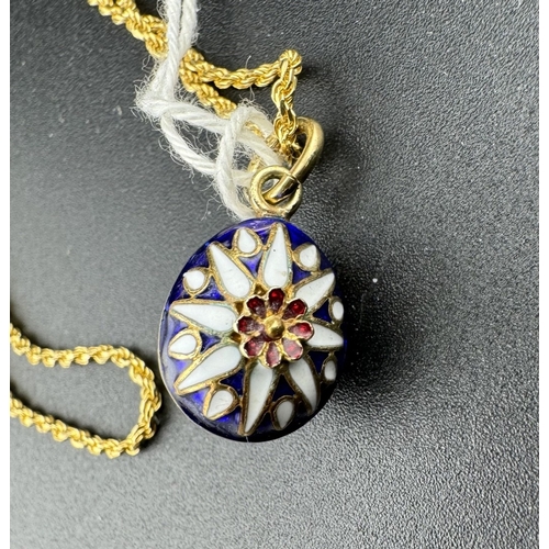 880 - Jewellery: Jewellery: An enamelled gold egg style pendant necklace, the 60cm chain marked 750 and te... 