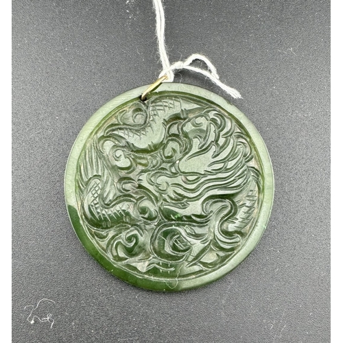 891 - Jewellery: Jewellery: A yellow metal mounted jadeite or nephrite pendant, one side carved with a hoh... 