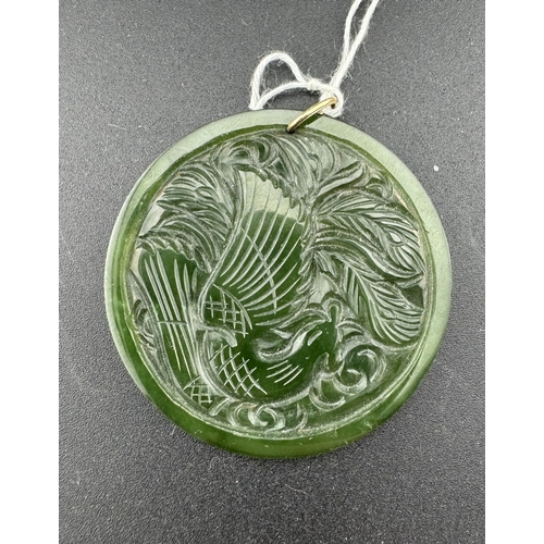 891 - Jewellery: Jewellery: A yellow metal mounted jadeite or nephrite pendant, one side carved with a hoh... 