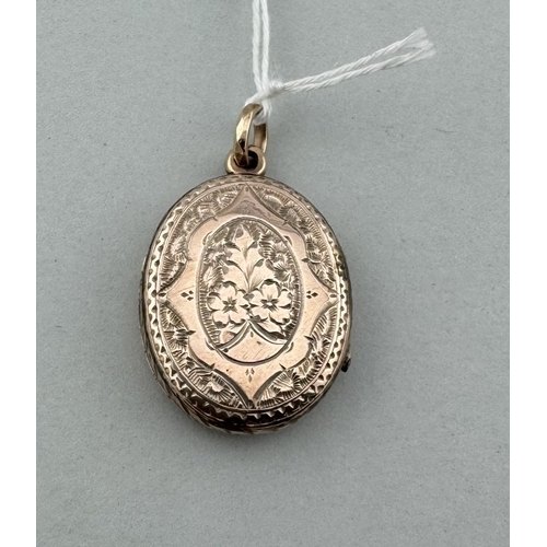 902 - Jewellery: Jewellery: A yellow metal oval locket, marked 9ct and testing as such, engraved with flow... 