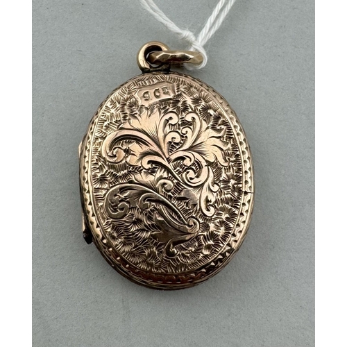 902 - Jewellery: Jewellery: A yellow metal oval locket, marked 9ct and testing as such, engraved with flow... 