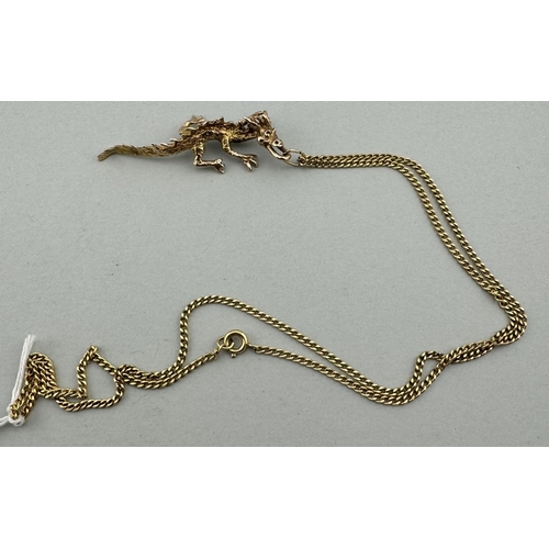 909 - Jewellery: Jewellery: A 9ct gold dragon pendant, depicted walking on all fours, 5.4g, on a gold plat... 