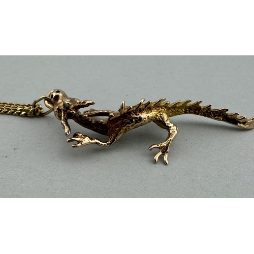 909 - Jewellery: Jewellery: A 9ct gold dragon pendant, depicted walking on all fours, 5.4g, on a gold plat... 