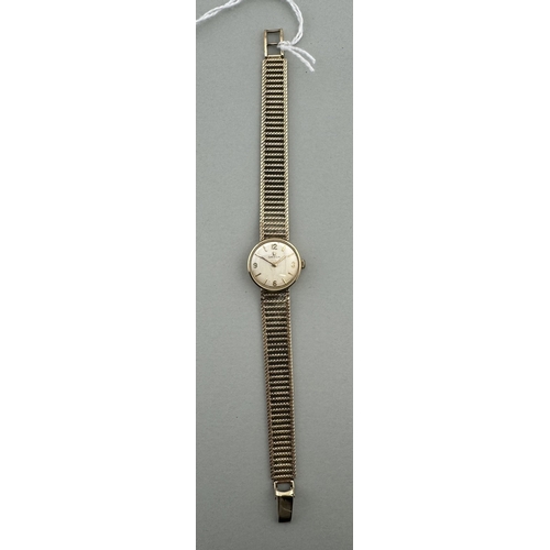 949 - Watches: Watches: A ladies 9ct gold cased Omega watch, 620 cal movement, with integral gold mesh str... 