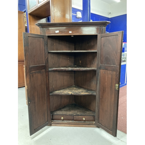 1 - Furniture: George III mahogany wall mounted corner cupboard twin panelled door opens to reveal shape... 