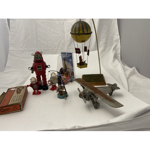 514 - Toys and games: Tin plate and metalware hot air balloons and rockets etc.