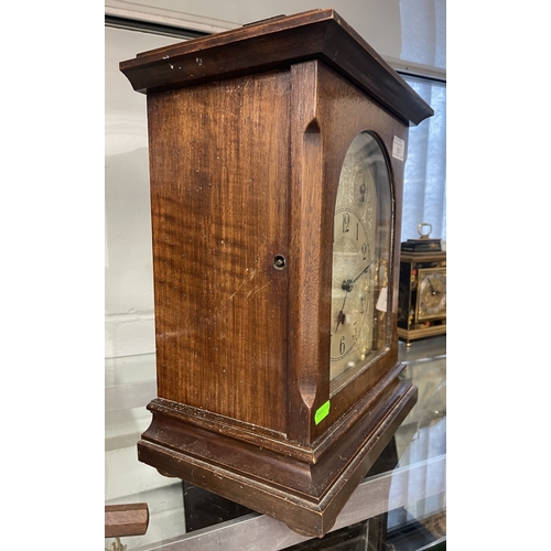 551 - Clocks: A 20th century German oak cased three train mantel clock with silvered dial and subsidiary d... 