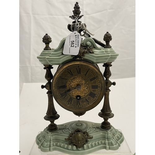 562 - Clocks: A garniture of brass and porcelain portico style clock by Lenzkirch, with matching candlesti... 