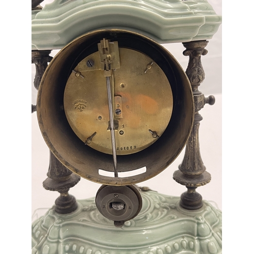 562 - Clocks: A garniture of brass and porcelain portico style clock by Lenzkirch, with matching candlesti... 