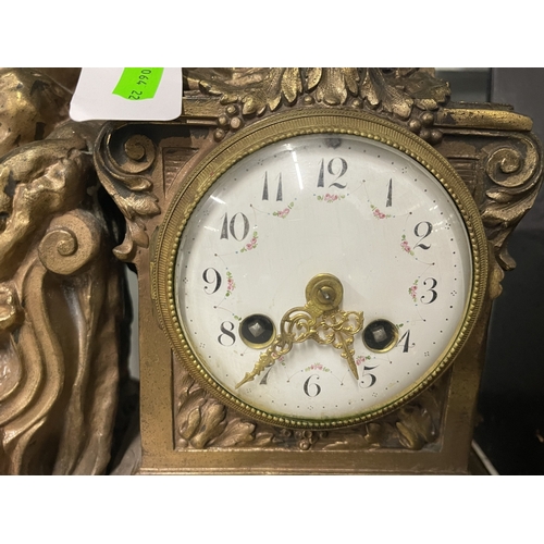 563 - Clocks: A late 19th century mantel clock, a gilt spelter figurine of a reclining maiden admiring her... 