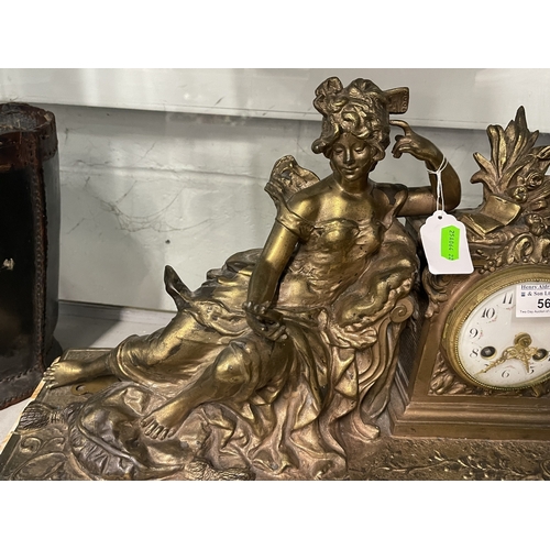 563 - Clocks: A late 19th century mantel clock, a gilt spelter figurine of a reclining maiden admiring her... 